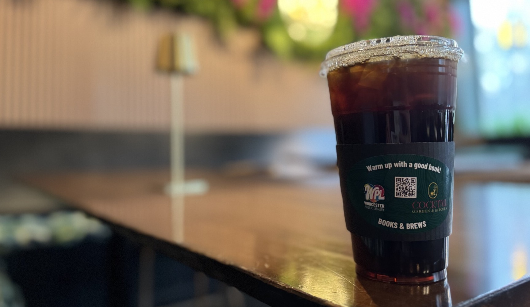 WPL custom coffee sleeve on cup of iced coffee